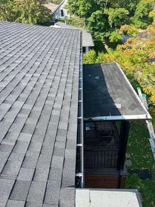 Before service: gutter filled with sludge and organic debris in Boucherville